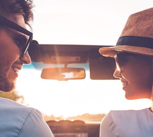 Couple riding in car into the sunset